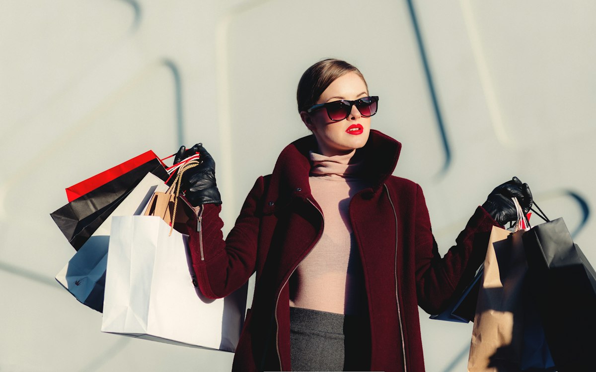 Shopper carrying gift bags in bright daylight